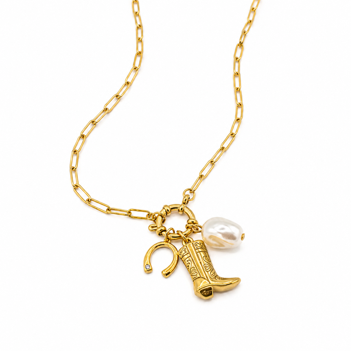 A gold chain necklace featuring a western-themed charm set with a cowboy boot, horseshoe, and a baroque pearl