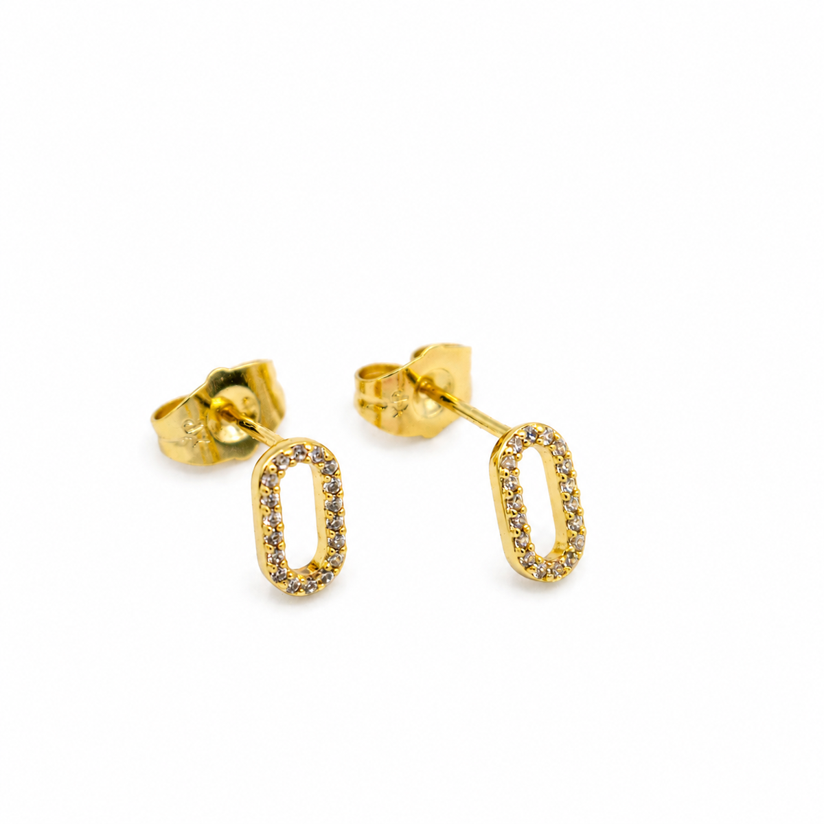 A pair of gold oval stud earrings with small clear stones set along the front edge