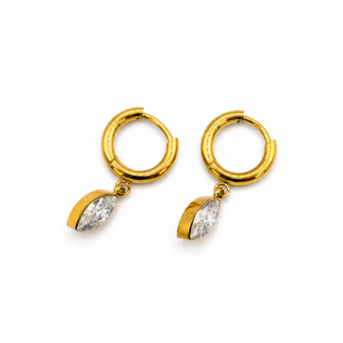 A pair of gold huggie hoop earrings with marquise-cut clear gemstones