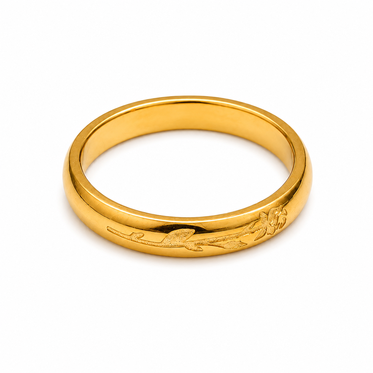 A polished yellow gold band ring featuring an engraved floral design on one side