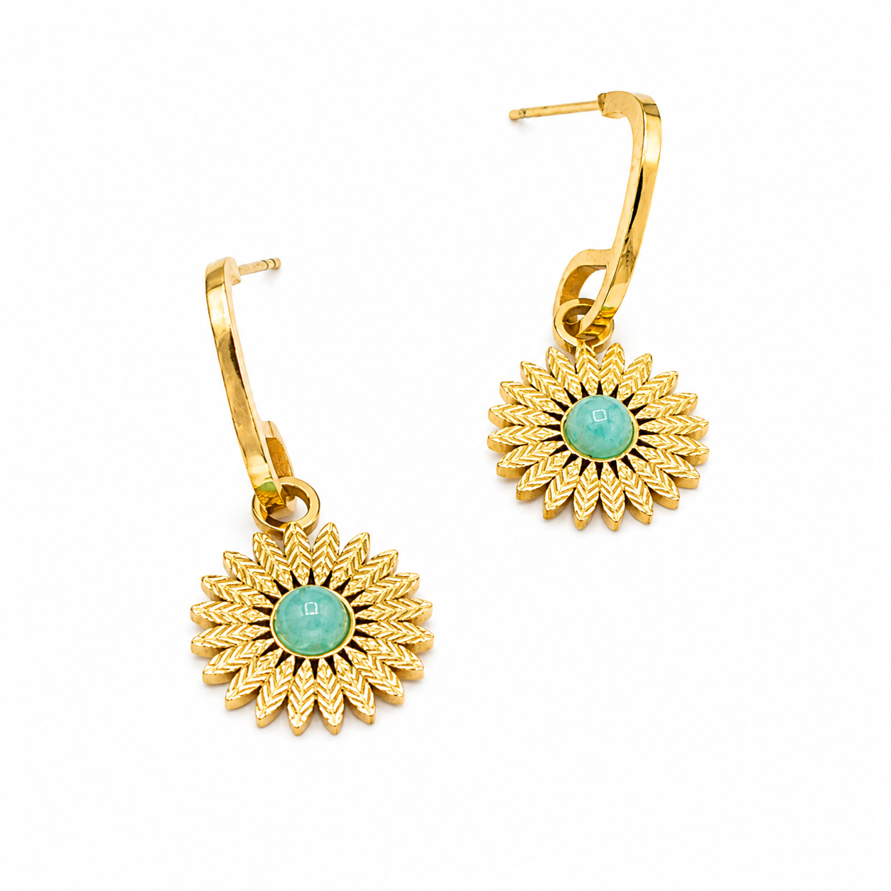 A pair of gold leverback earrings featuring textured sunburst flower charms with round light green cabochon centers