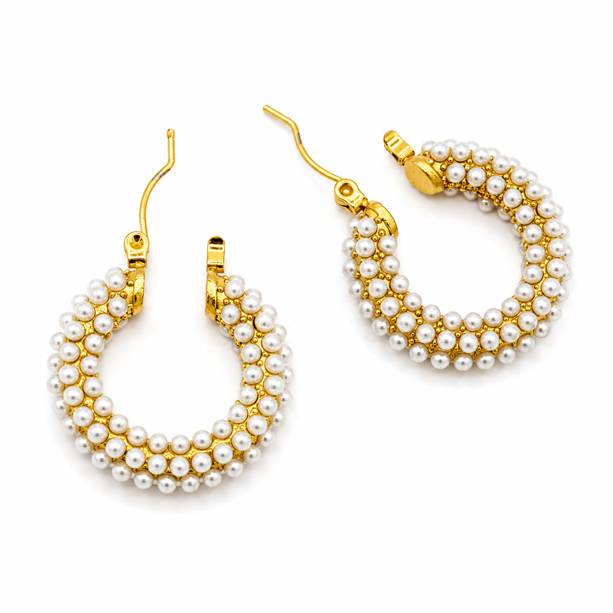 A pair of gold hoop earrings adorned with multiple rows of small white faux pearls