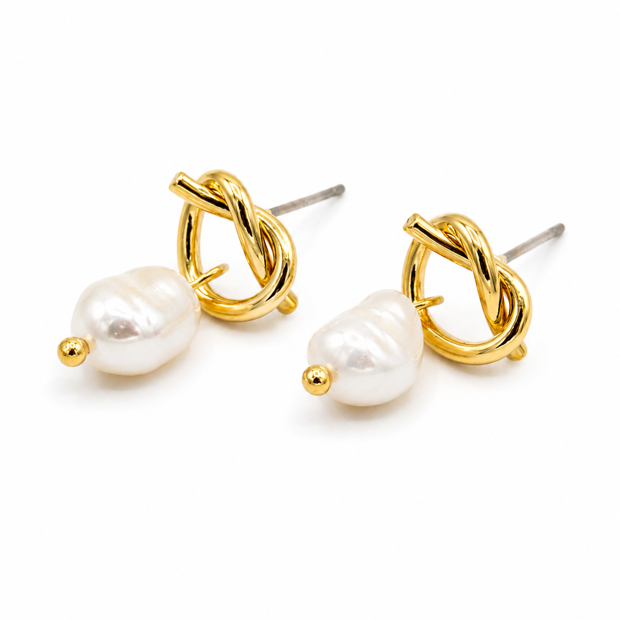A pair of gold knot stud earrings with a small white baroque pearl drop and a tiny gold bead accent