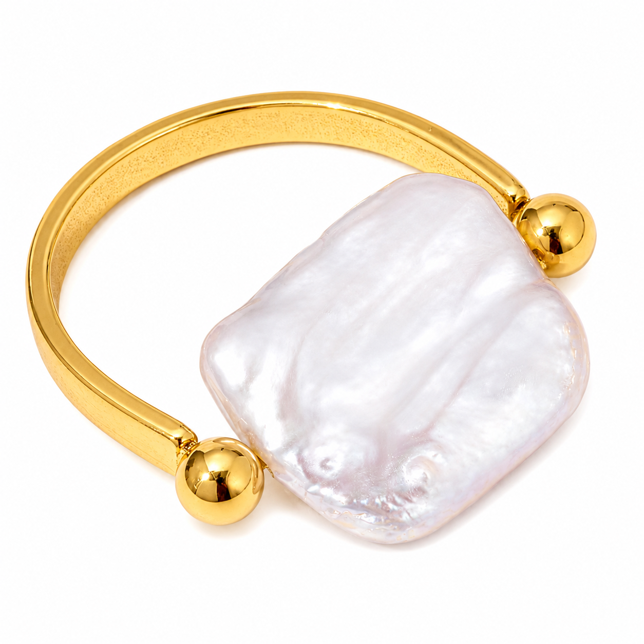 A gold-plated bangle bracelet featuring a large, irregular-shaped white pearl as the main setting