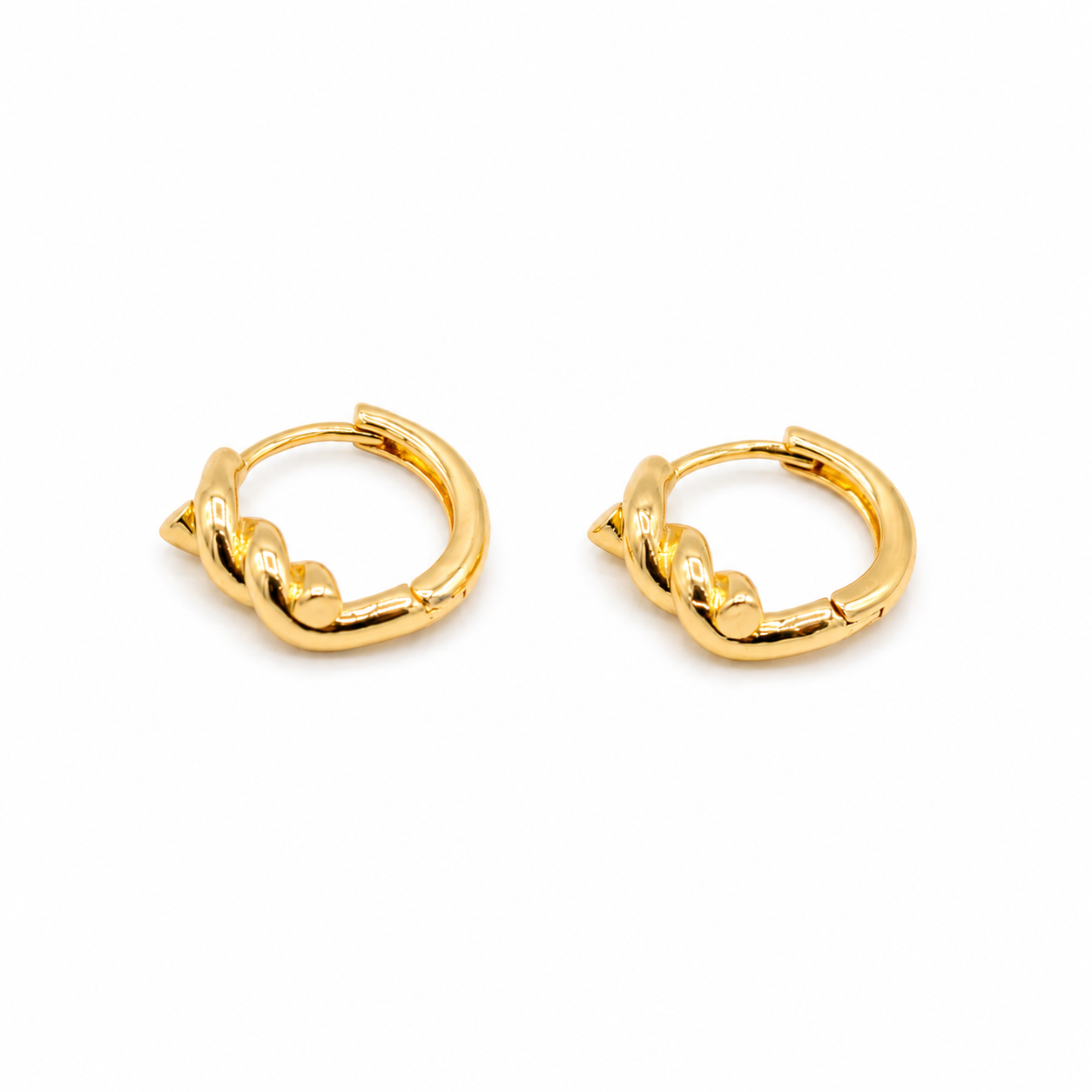 A pair of small gold huggie hoop earrings with a twisted knot design