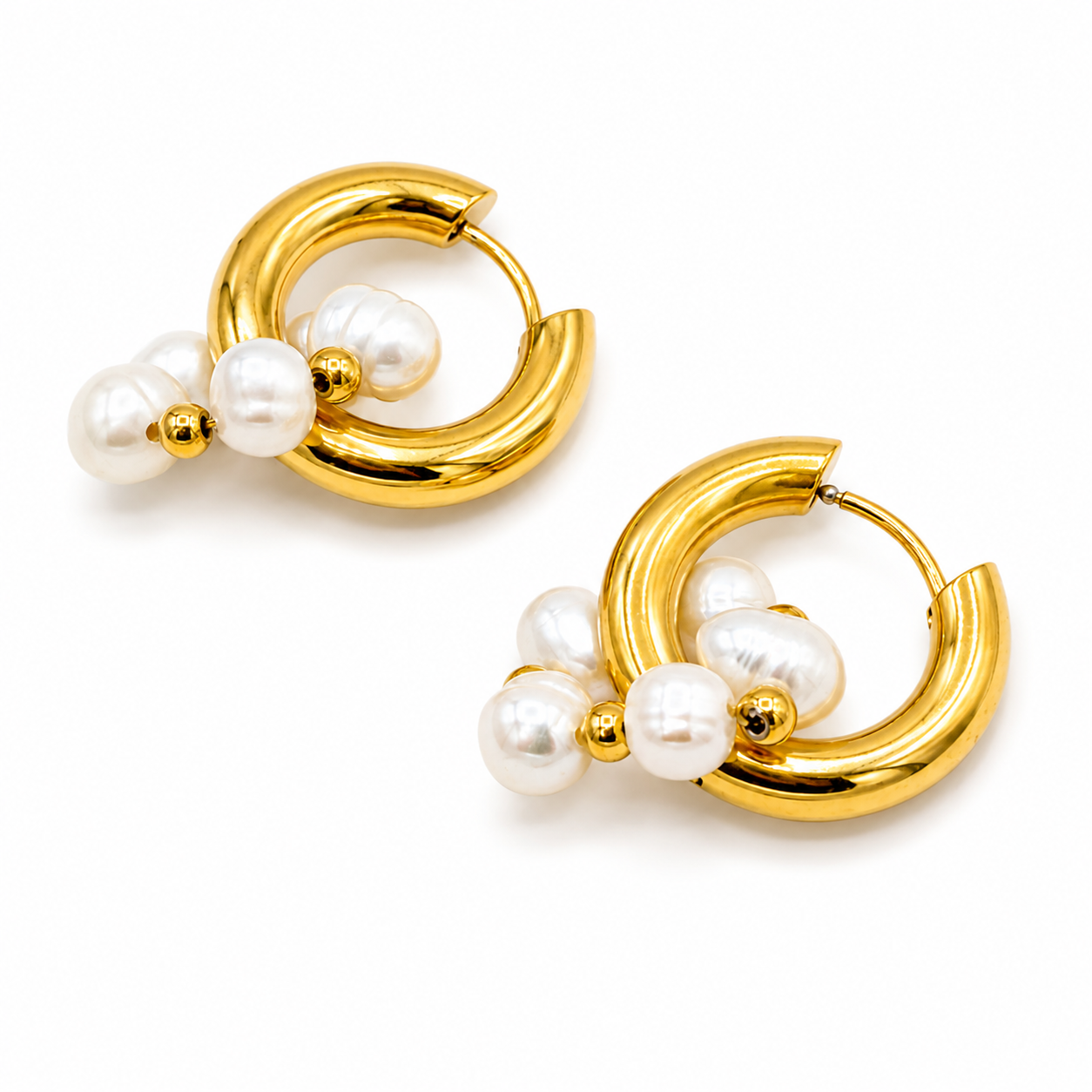A pair of gold hoop earrings with clusters of white freshwater pearls and small gold beads