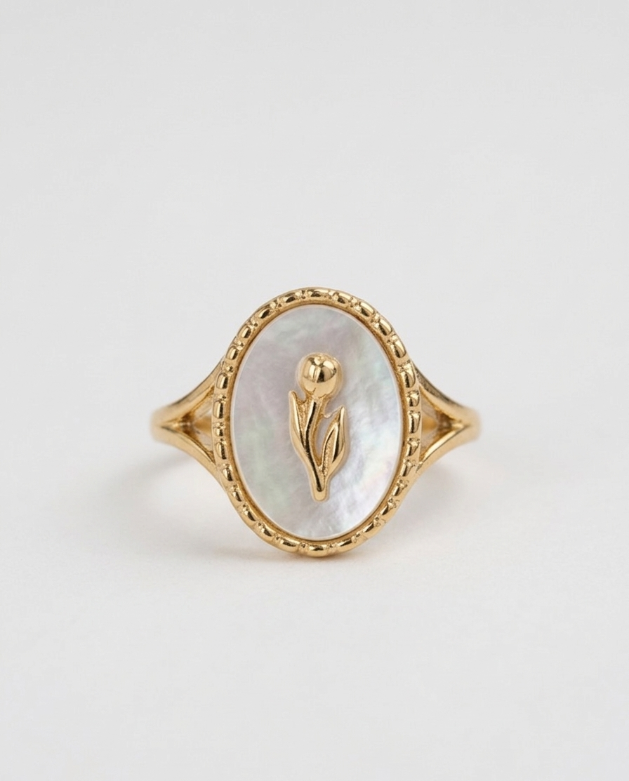 Gold ring with a golden flower set in pearl oval with studded design