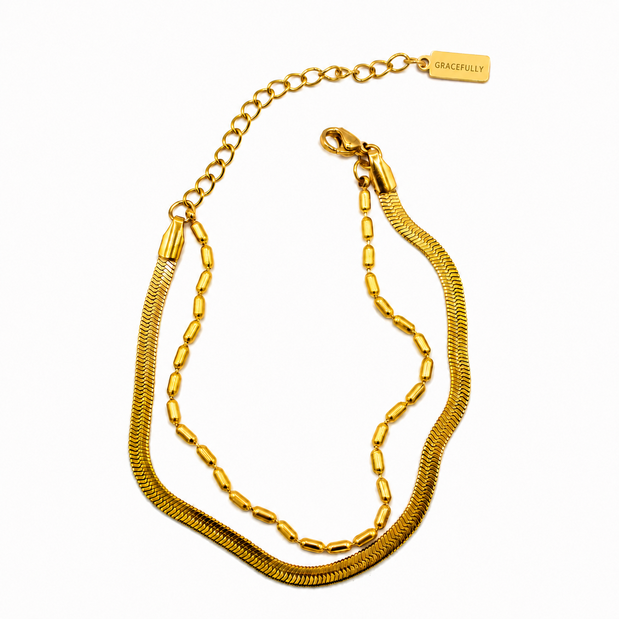 A gold double strand necklace featuring a textured snake chain and a smoother link chain with a lobster clasp and extender chain
