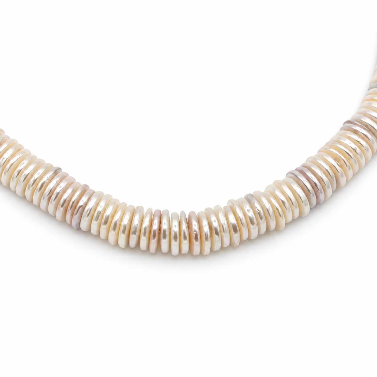 A close-up of a beaded necklace made of small, horizontally stacked, disc-like beads in a warm cream, ivory, and light tan color