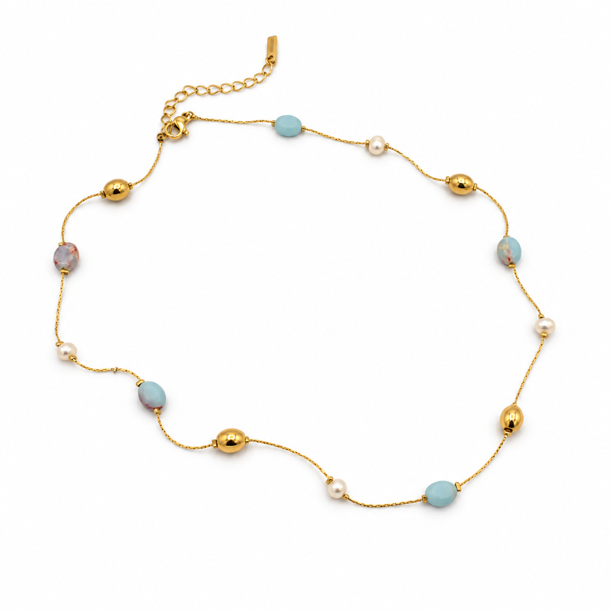 A delicate gold chain necklace featuring alternating light blue oval beads, small white pearl-like beads, and polished gold spacer beads