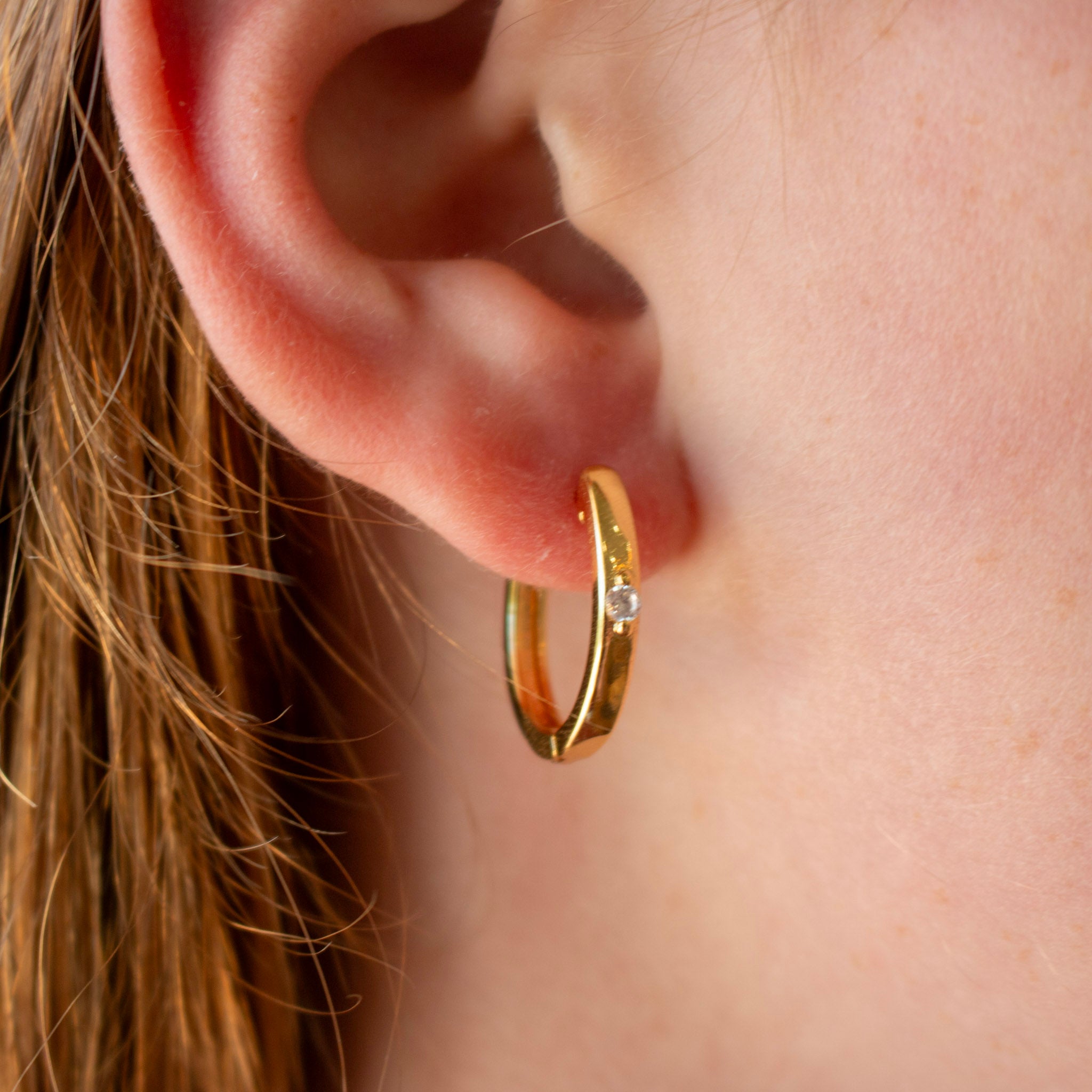 gold hoop earring with a diamond