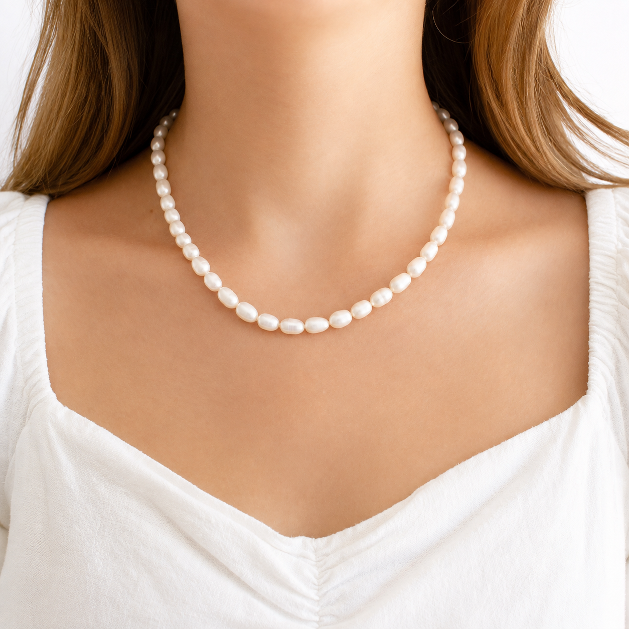 woman wearing a classic freshwater pearl necklace with irregular white pearls