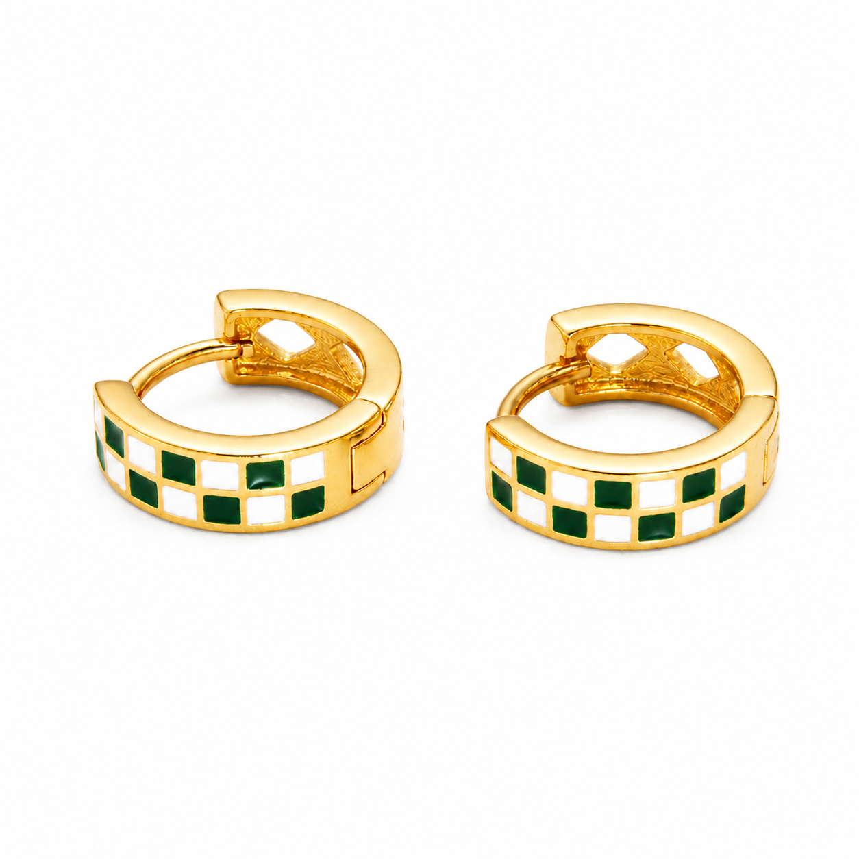 A pair of gold huggie hoop earrings with a checkered pattern of green and white enamel