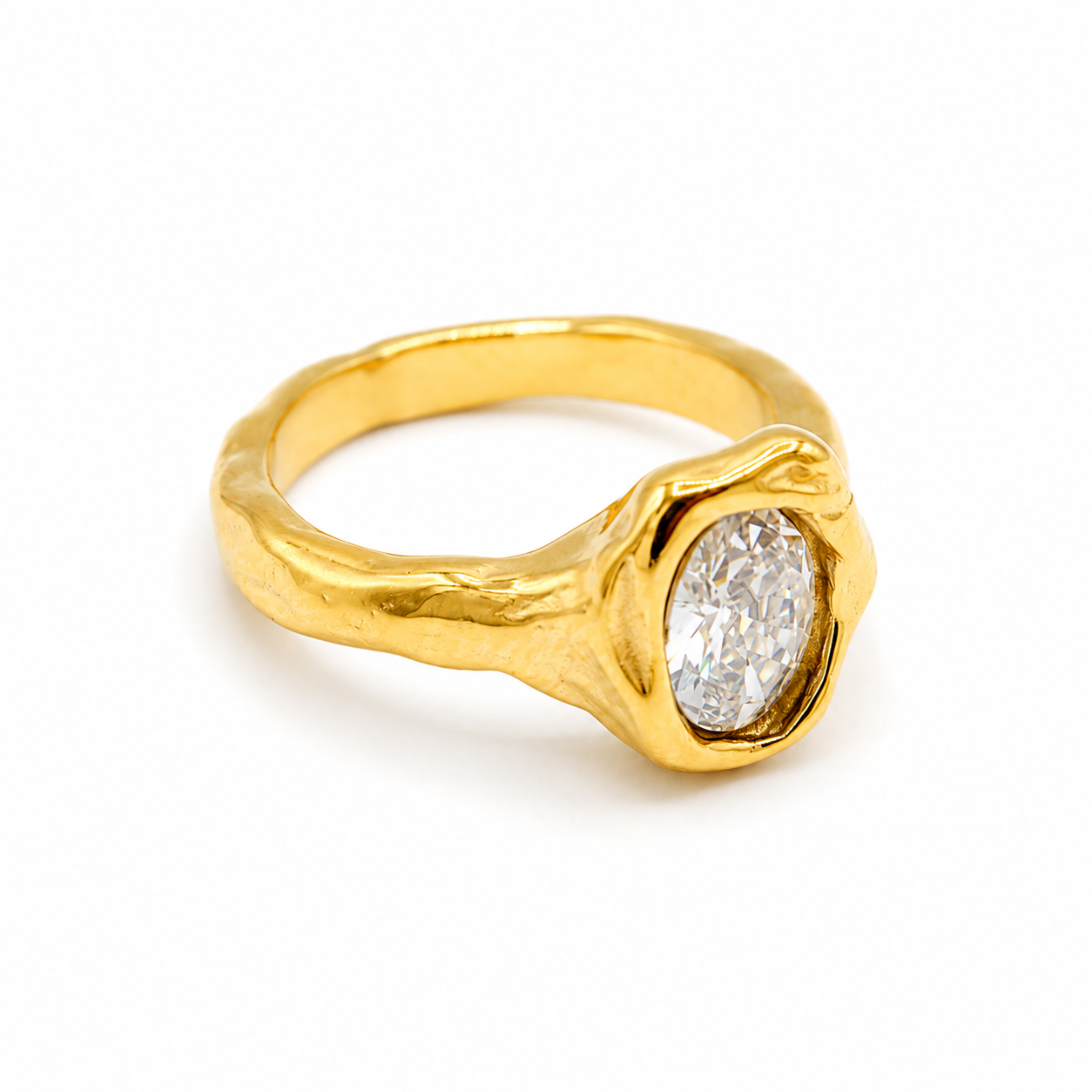A gold ring with a textured, organic-shaped band and a bezel-set oval clear gemstone