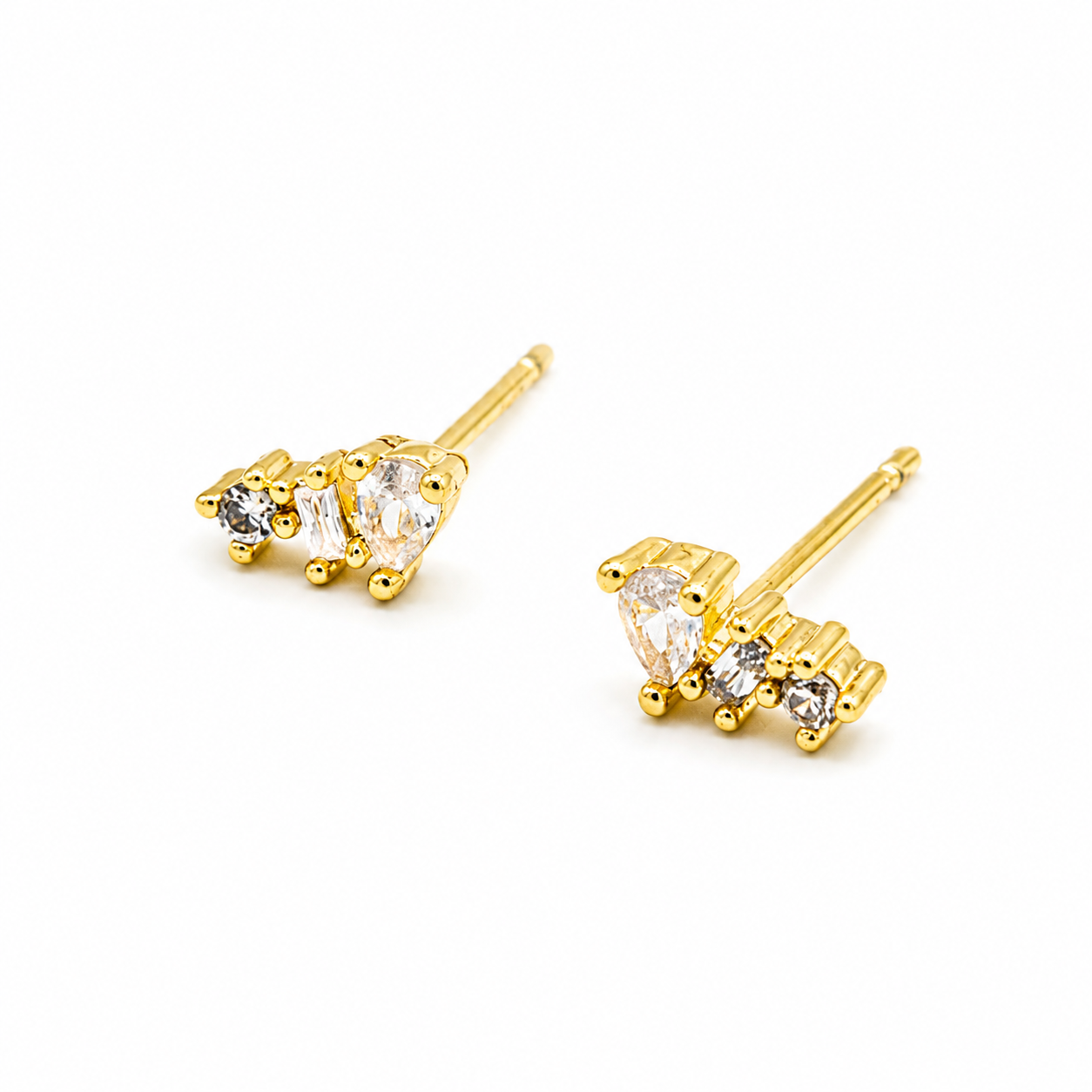 A pair of gold stud earrings featuring small clear gemstones