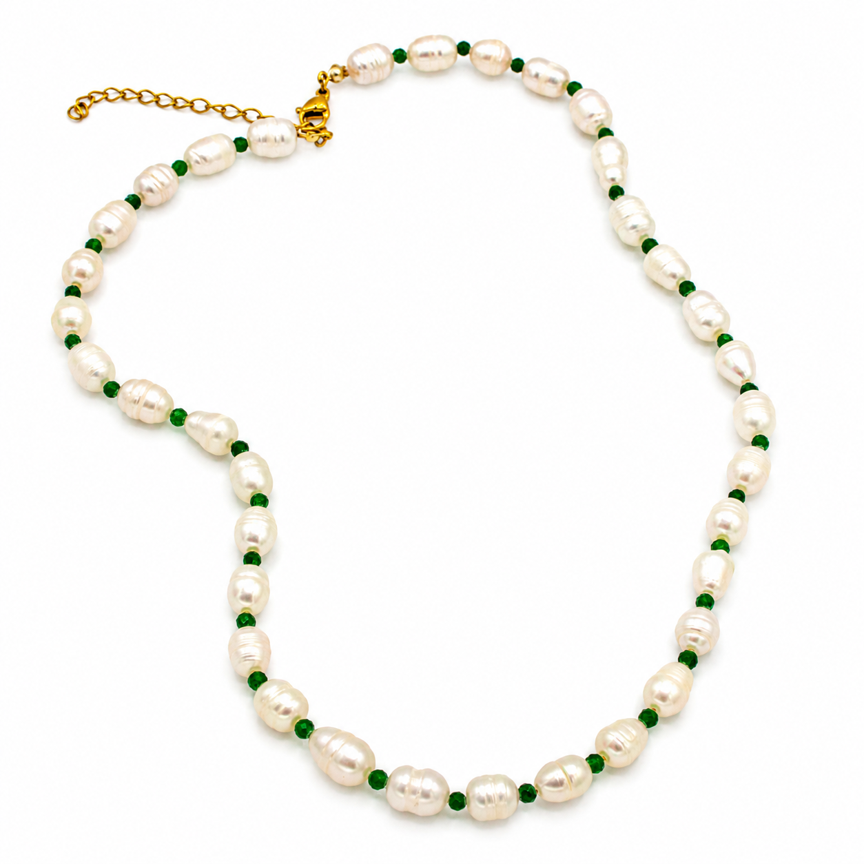 A baroque pearl necklace with small green gemstone accents and a gold clasp