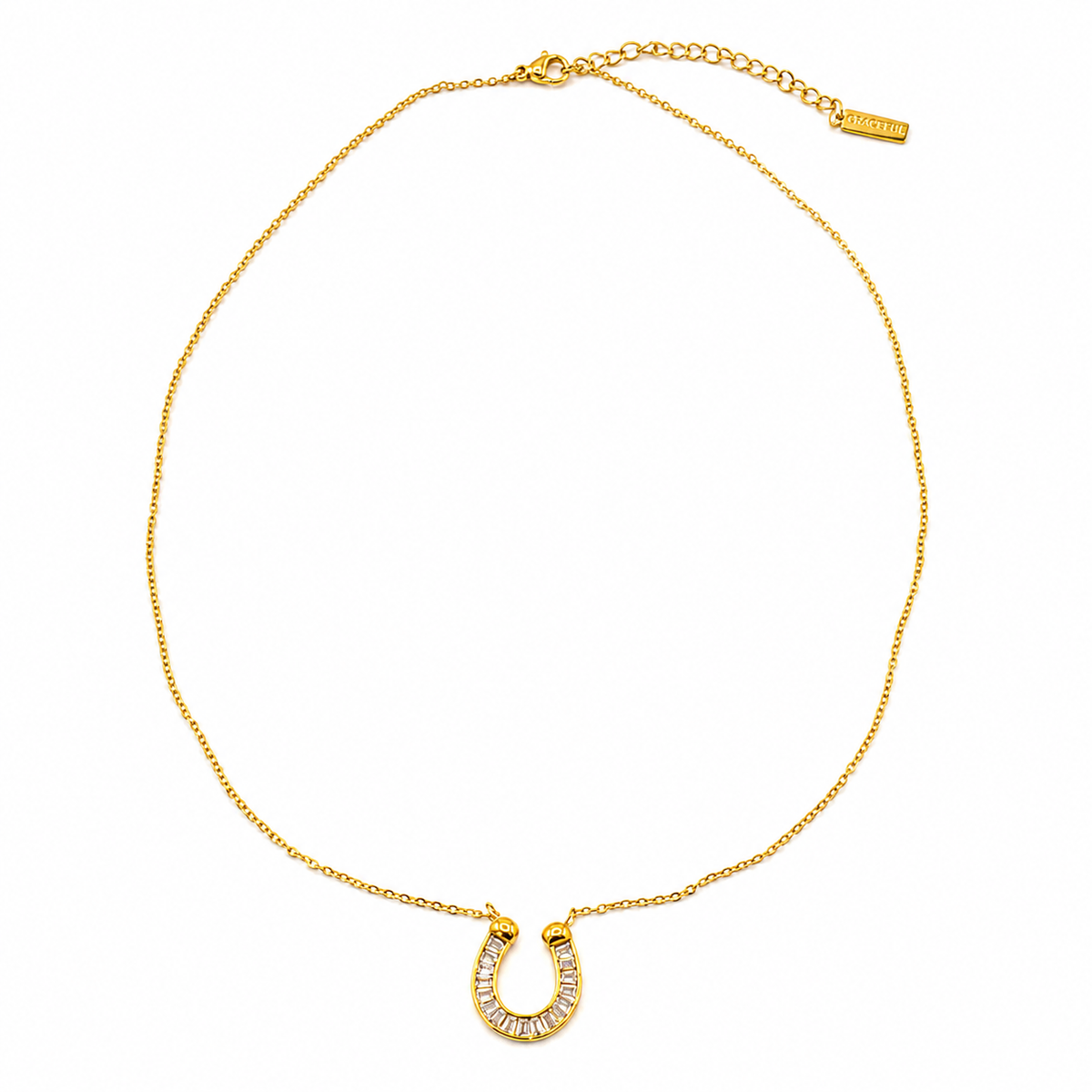 A gold chain necklace featuring a horseshoe-shaped pendant paved with small clear stones