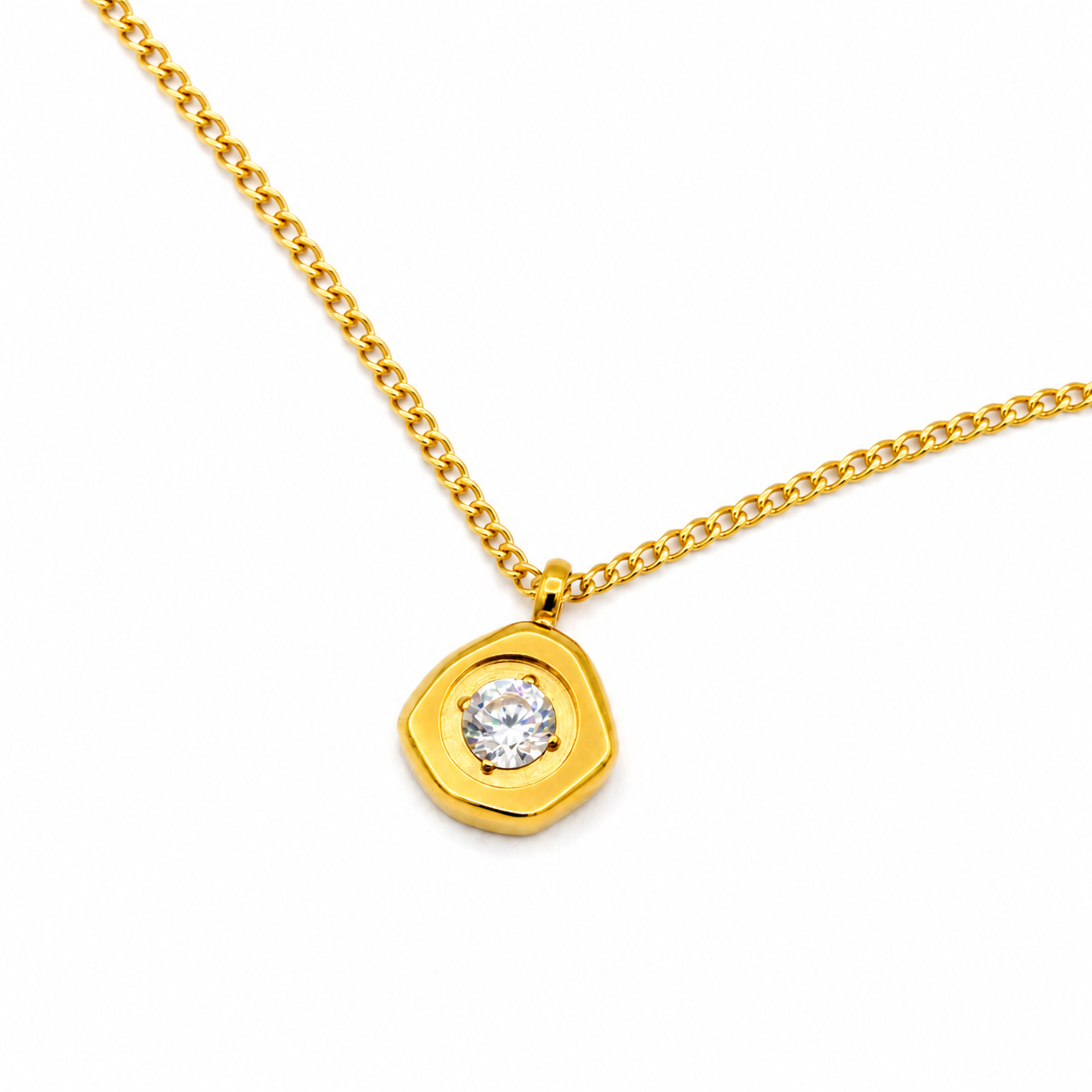 A gold chain necklace with a unique, organic-shaped gold pendant featuring a single round clear gemstone
