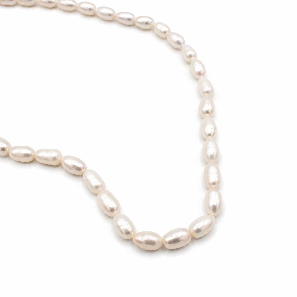 A strand of irregular, baroque-style white freshwater pearls 