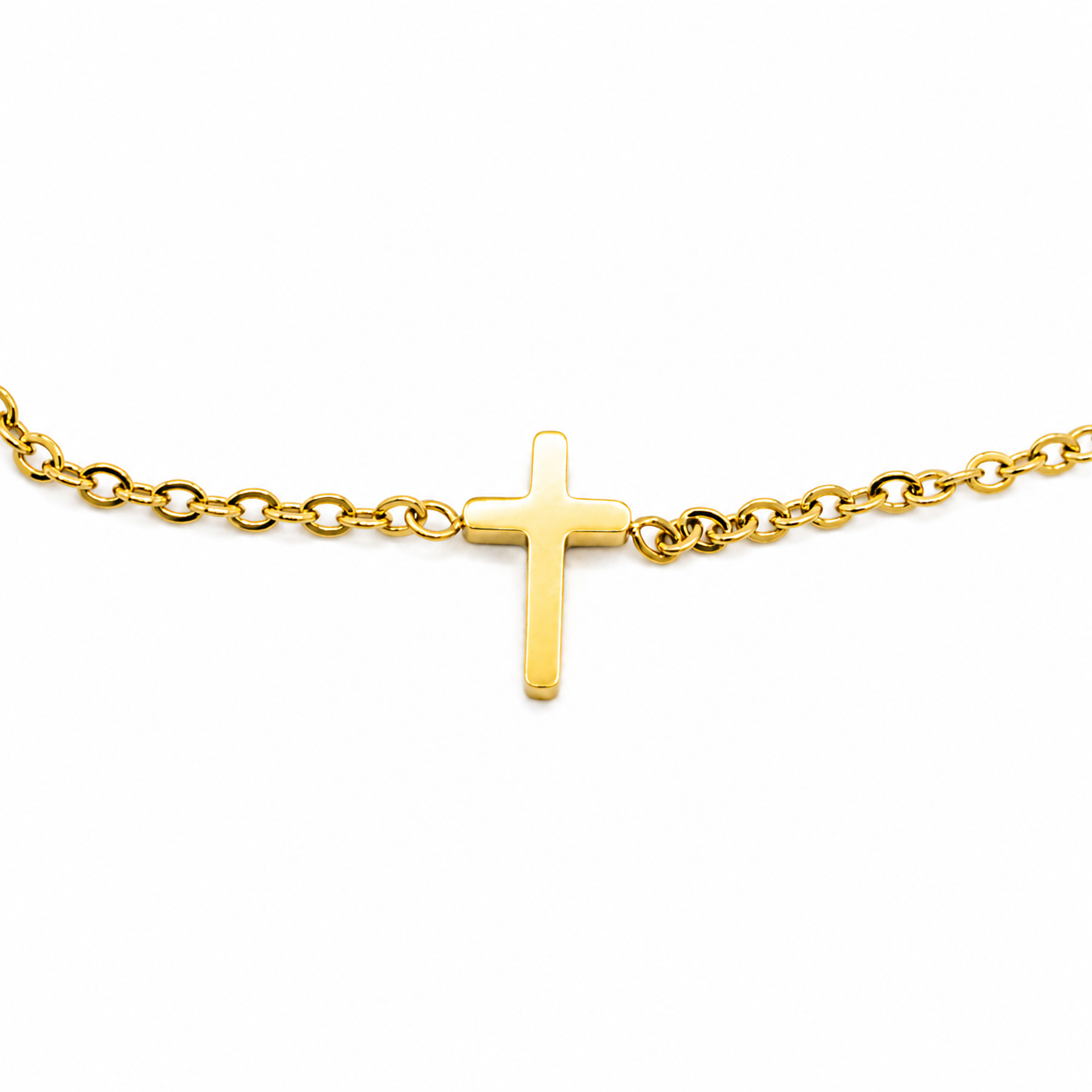 A polished yellow gold cross pendant on a matching gold chain
