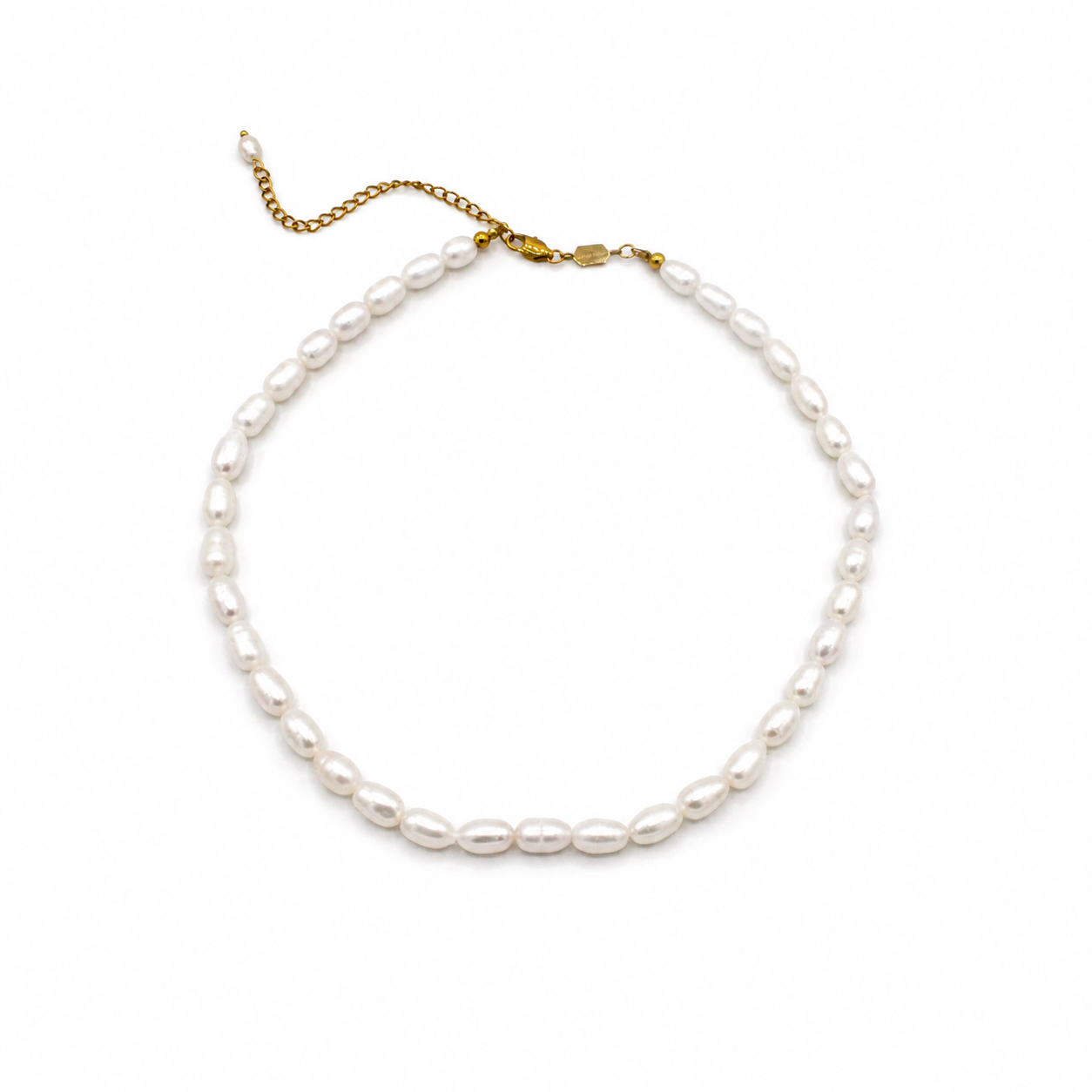 A baroque pearl necklace with a gold chain extender and lobster clasp