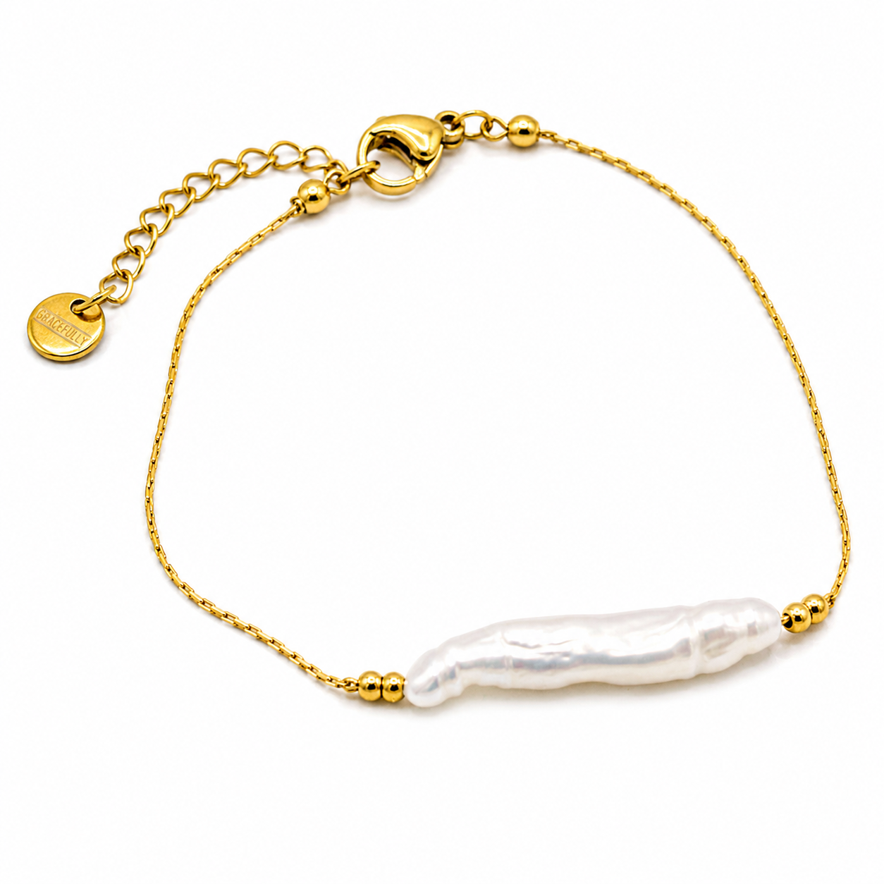 A delicate gold chain bracelet featuring a single, irregular white baroque pearl bead