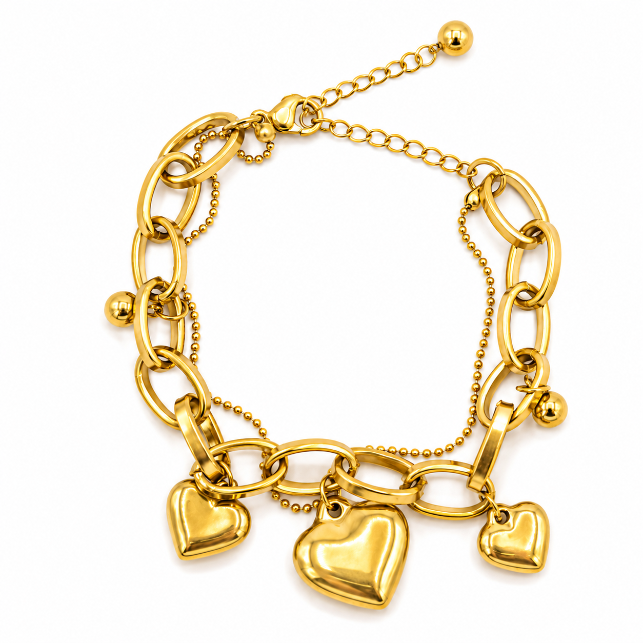 A gold charm bracelet featuring a chunky link chain, a delicate beaded chain, and three dangling heart charms