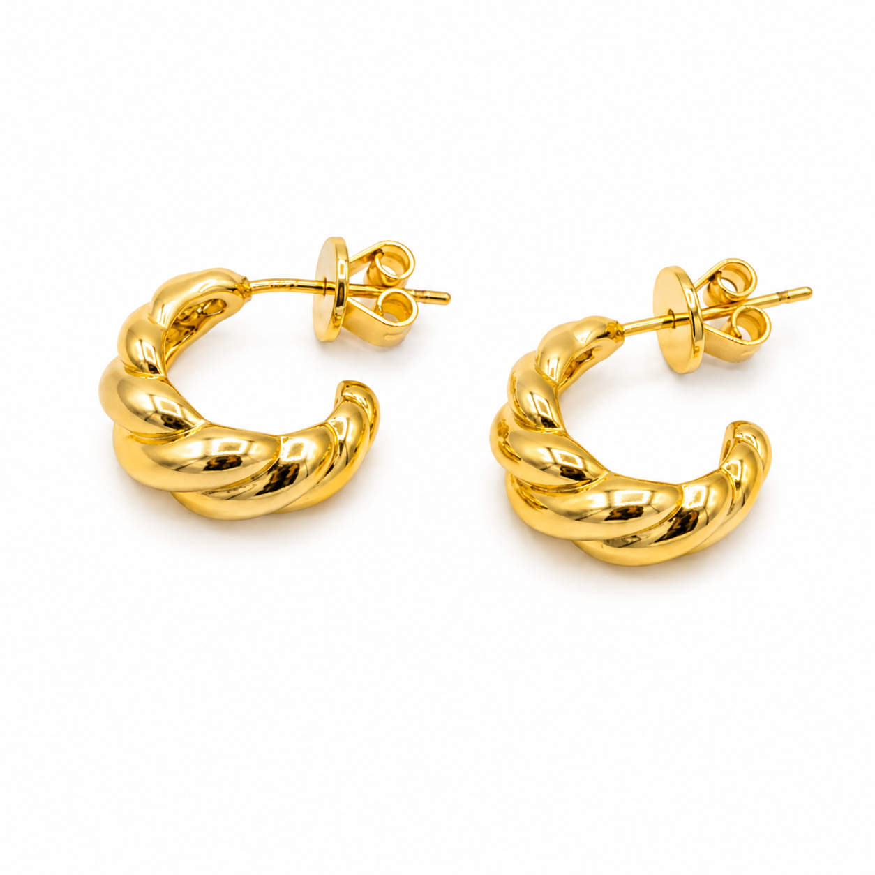 A pair of polished yellow gold huggie hoop earrings with a twisted rope texture