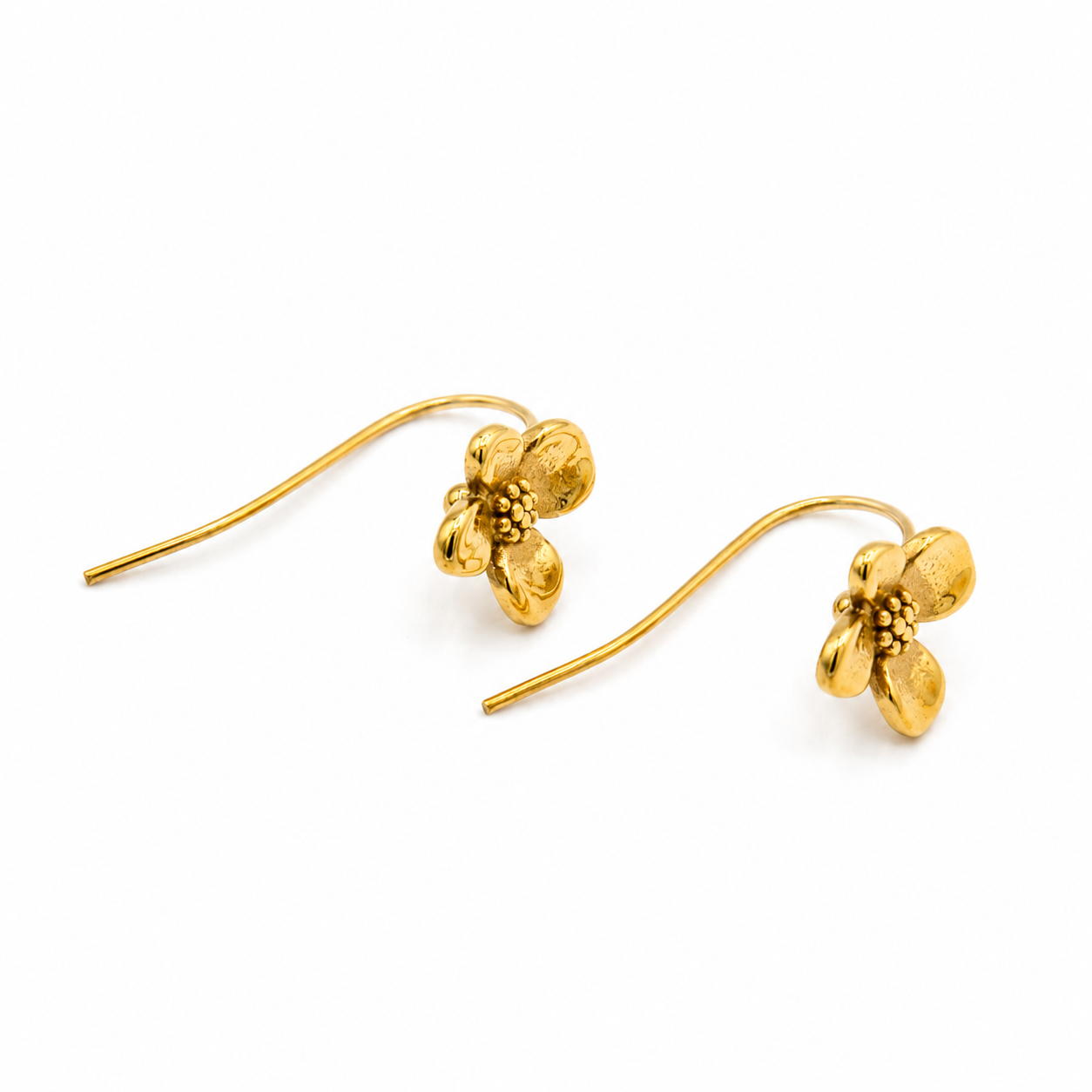 A pair of gold flower-shaped drop earrings with textured petals and curved wire hooks
