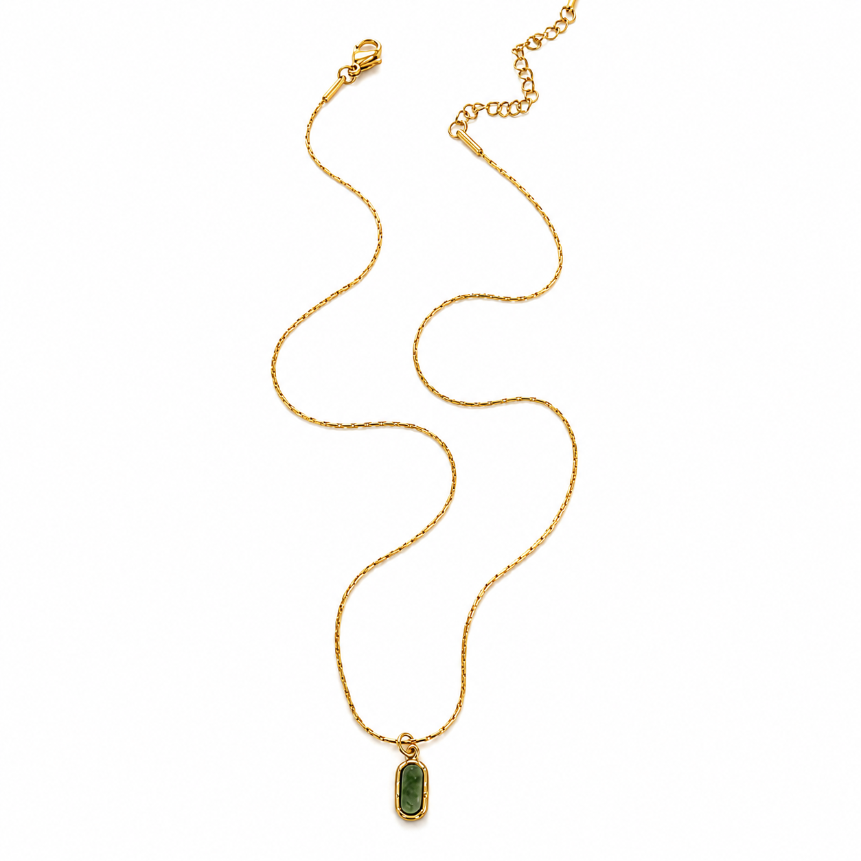 A gold chain necklace with a small rectangular green stone pendant
