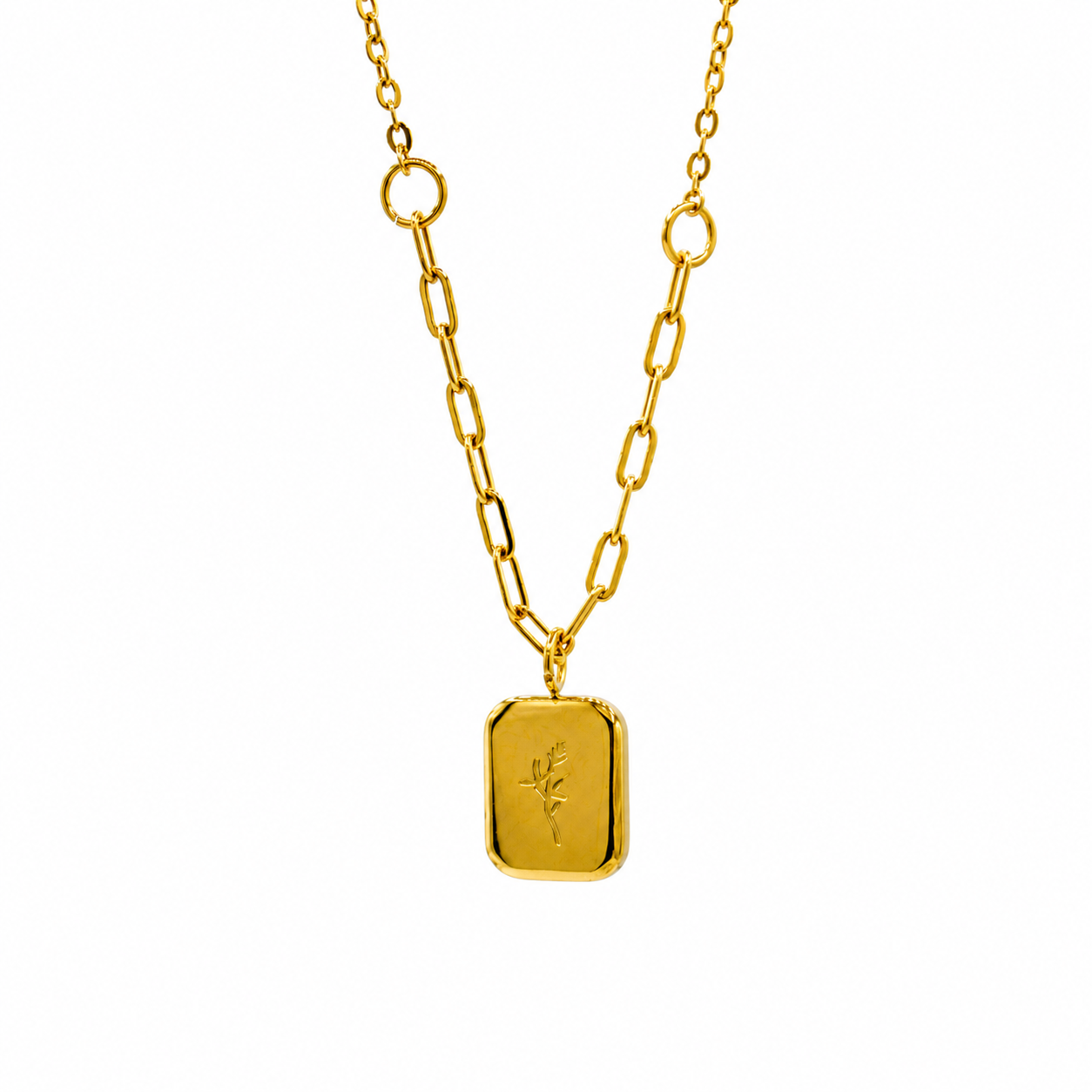A gold chain necklace featuring a rectangular pendant with rounded corners and an engraved symbol