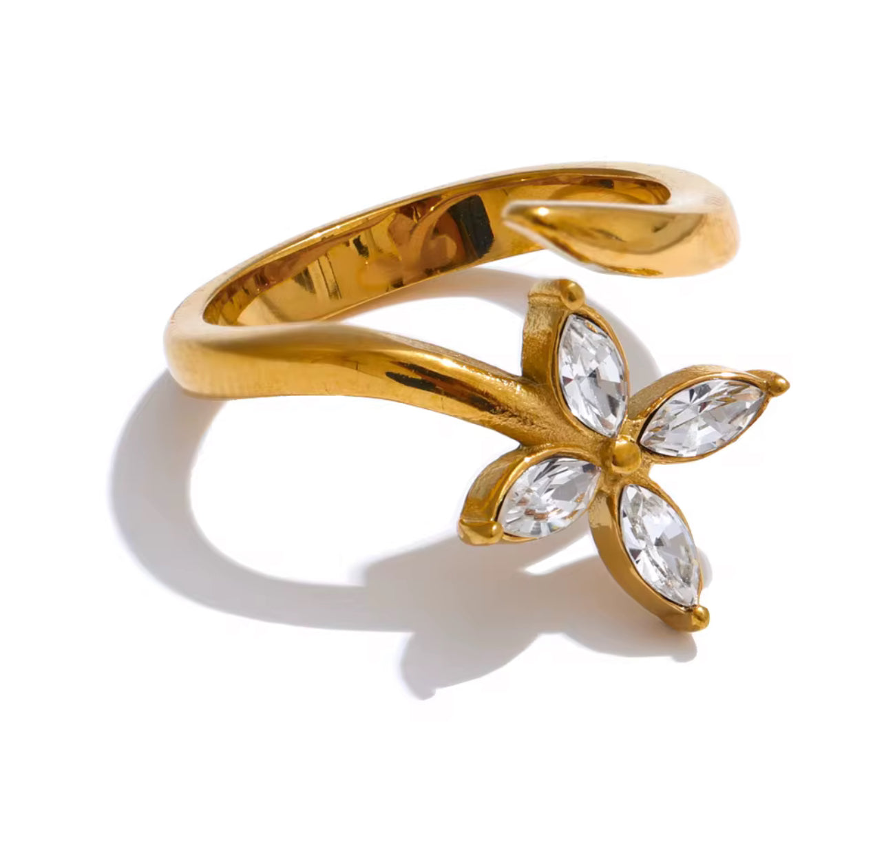Gold butterfly-shaped ring with clear gemstones on a white background