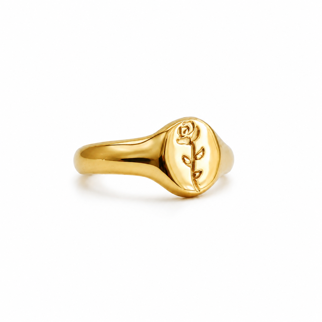 A polished yellow gold signet ring featuring an engraved rose on a flat oval face