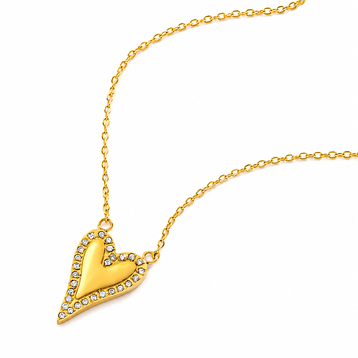 A gold heart pendant necklace with a polished finish and a border of small clear rhinestones