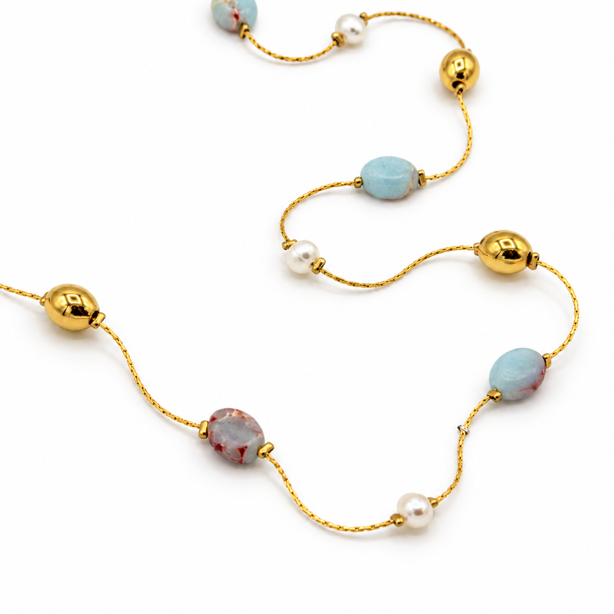 A gold chain necklace featuring light blue and pinkish-beige marbled beads, white pearls, and polished gold spacer beads