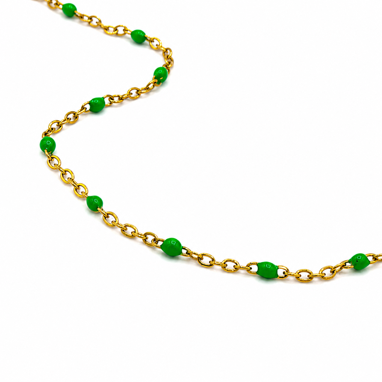 A gold chain necklace featuring alternating green bead links and small green oval beads