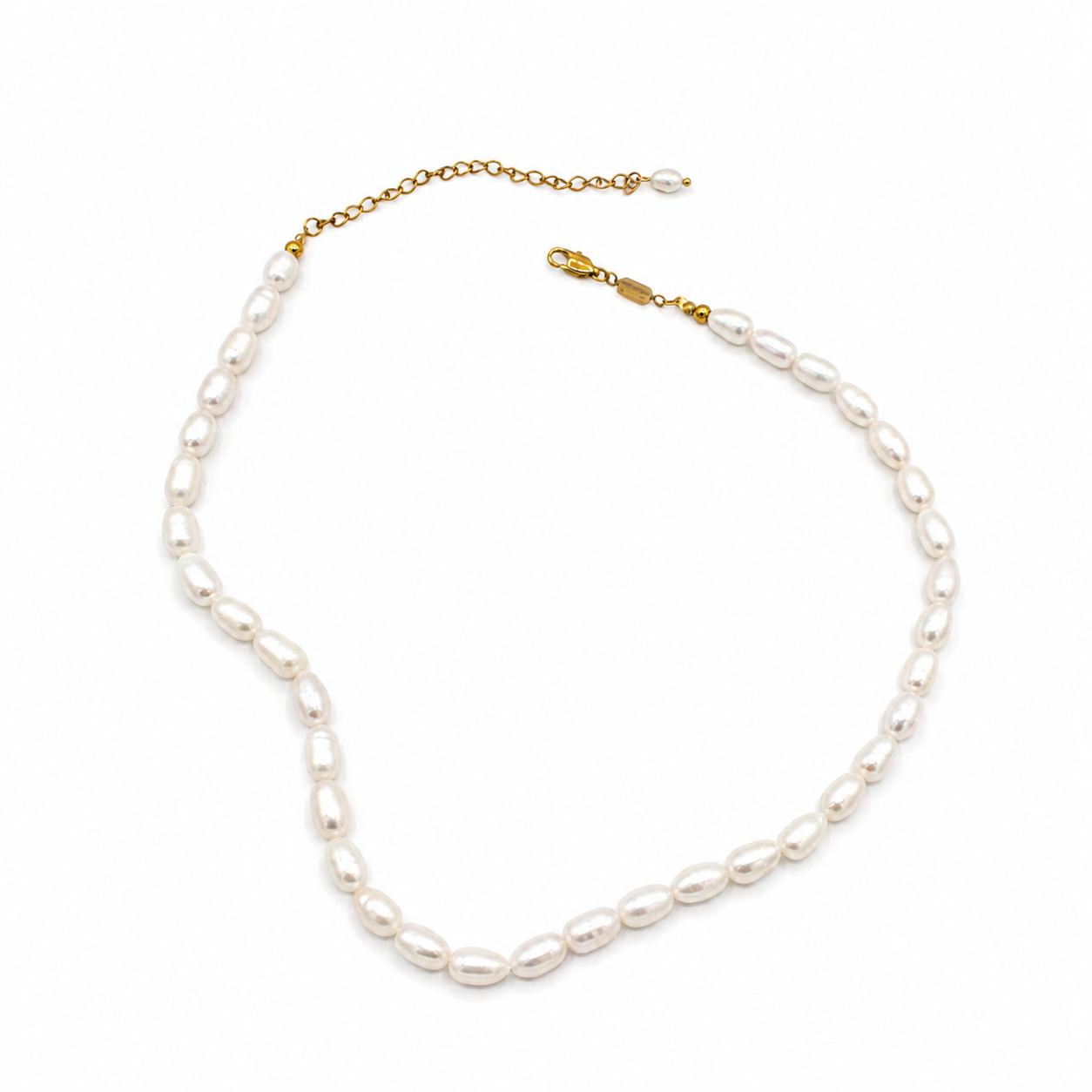 A baroque pearl necklace with a gold chain extender and lobster clasp