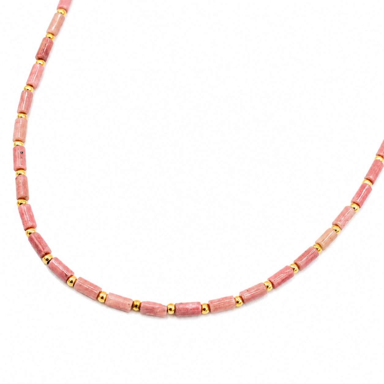 A beaded necklace featuring cylindrical pink stone beads separated by small gold spacer beads