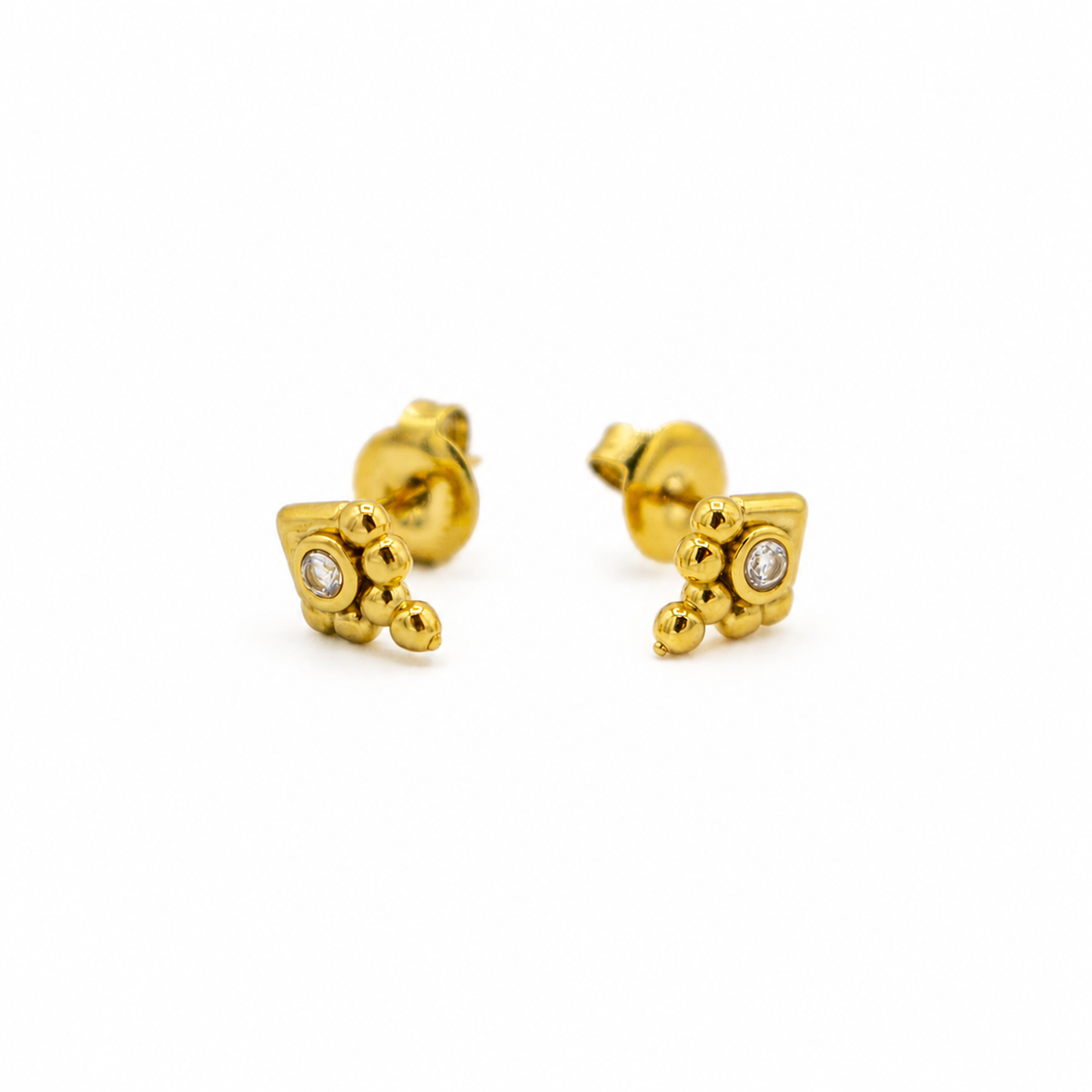 A pair of gold stud earrings with a textured, geometric cube-like front face, each set with a small clear gemstone,