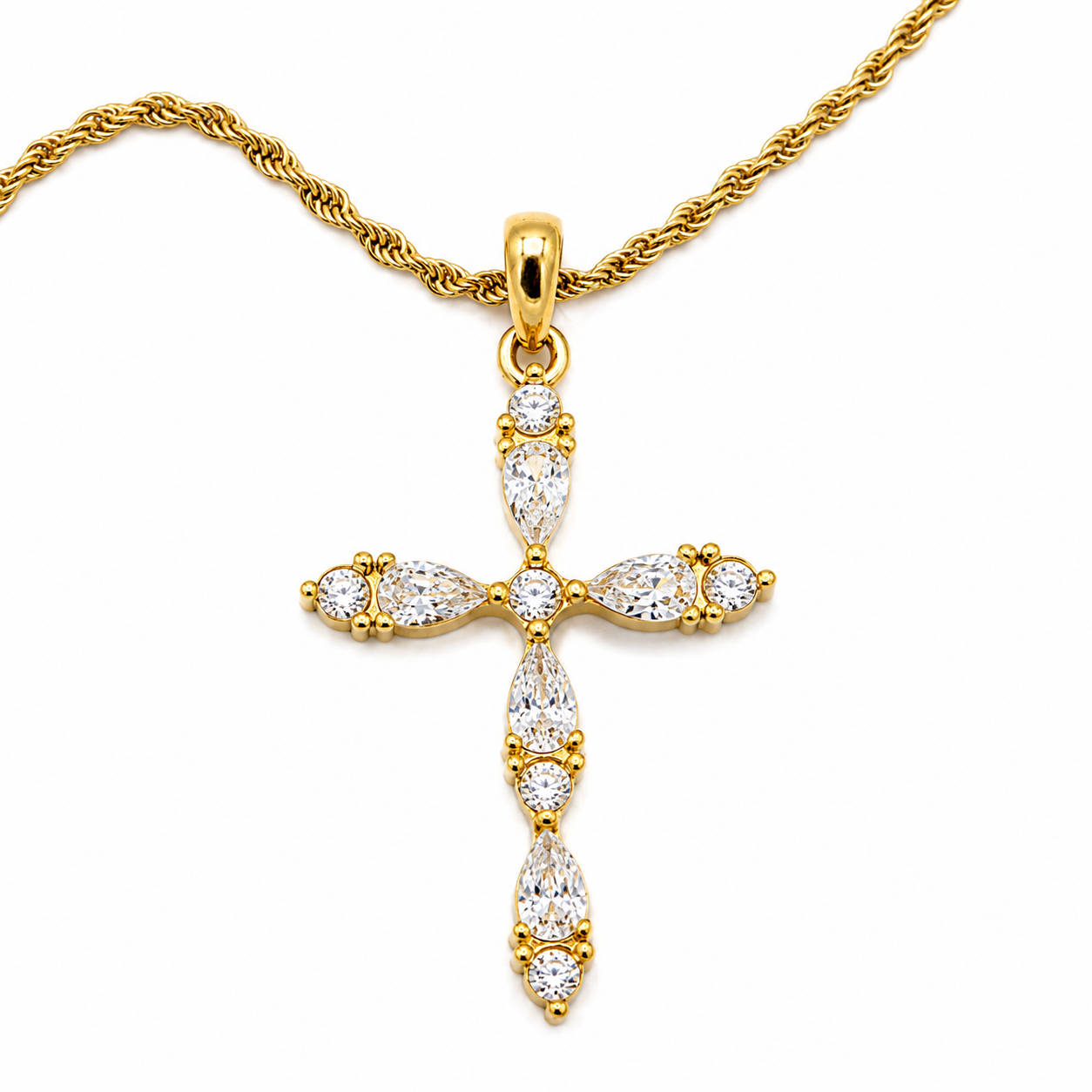 A gold cross pendant necklace adorned with clear marquise and round-cut gemstones, suspended from a gold chain