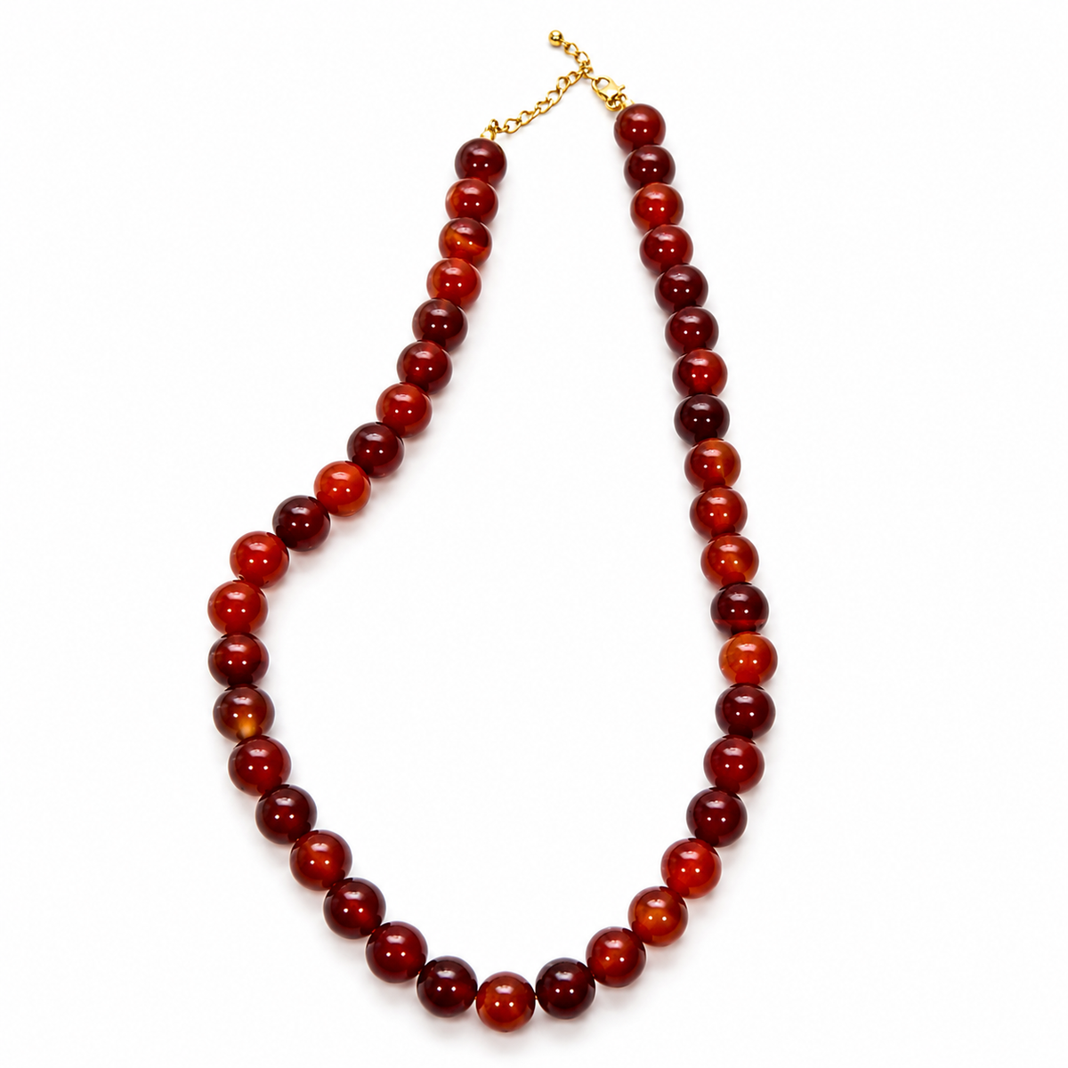 A beaded necklace made of polished round red and dark red gemstone beads, finished with a gold-tone clasp