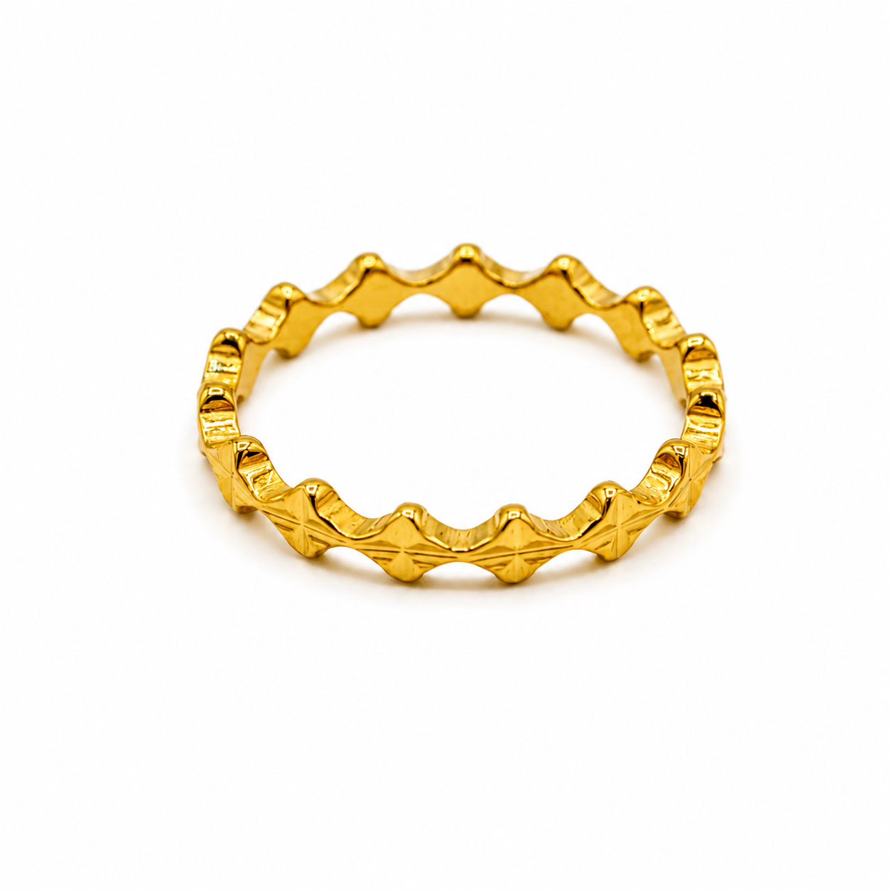 A textured gold ring with a wavy, segmented design