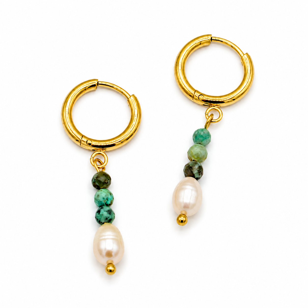 A pair of gold huggie hoop earrings with dangling beaded chains. Each earring features three small beads in green and dark brown, followed by a larger white baroque pearl and a tiny gold bead at the bottom